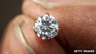 Diamond and fingertips generic image