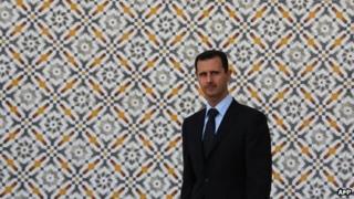 Syria's President Assad stands alone at Al-Shaab Palace in Damascus during a visit by the Greek President in 2009.