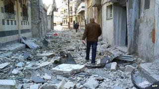 Debris seen in a street of the Syrian city of Homs after alleged shelling by government forces on 19 April 2012 (file picture)