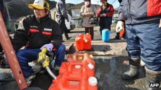 Consumer filling up heating oil containers