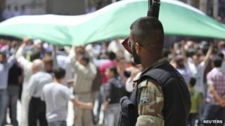 A member of the Free Syrian Army is seen during a demonstration against Syria's President Bashar al-Assad after Friday prayers in Idlib on 25 May