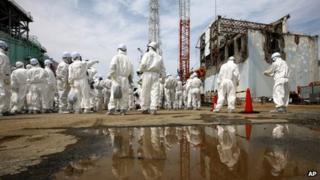 People in protective suits at Fukushima