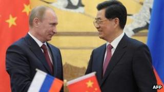 Chinese President Hu Jintao and his Russian counterpart Vladimir Putin shake hands during a signing ceremony at the Great Hall of the People in Beijing on 5 June, 2012