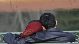Man and a woman sitting on a bench