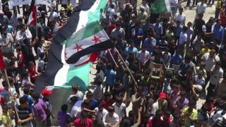 Demonstrators take part in a protest against Syria's President Bashar al-Assad in Sermeen, near the northern city of Idlib on 8 June 2012