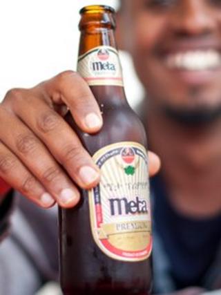 Man holding a bottle of Meta beer