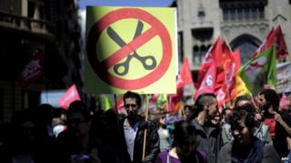 People protest during a May Day rally in the centre of Barcelona