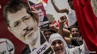 Supporters of Muslim Brotherhood candidate Mohammed Morsi celebrate his claiming victory in Cairo's Tahrir square on 18 June 2012