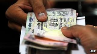Indian rupee notes being exchanged