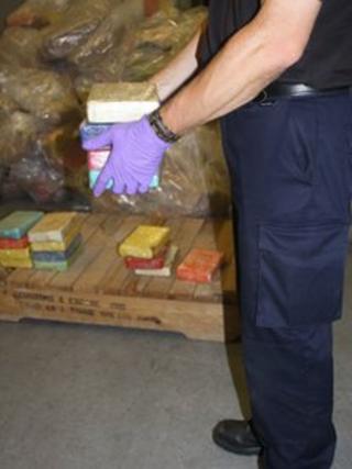 A UK border force officer holding some of the drugs