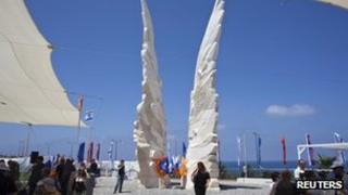 People walk next to a monument commemorating the victory of the Soviet Red Army in World War Two in the coastal city of Netanya which will be unveiled by Mr Putin