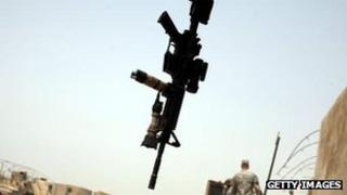 A gun hangs from truck door at US military base Kalsu on July 18, 2011 in Iskandariya, Babil Province Iraq.
