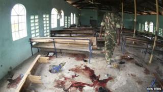 A Kenyan policeman walks inside the a church after an attack in Garissa on 1 July 2012