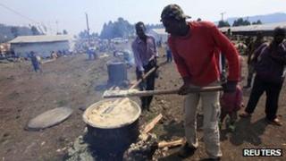 Congolese refugees prepare a meal at the Nyakabande refugee transit camp in Kisoro town