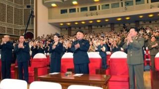North Korean leader Kim Jong-Un (C) applauds during a demonstration performance by the newly formed Moranbong band in Pyongyang in this undated picture released by the North"s KCNA July 9, 2012