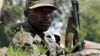 A M23 rebel fighter guards the venue of a news conference by the political leader Jean-Marie Runiga Rugerero in Bunagana, DR Congo
