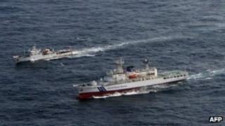 A Chinese patrol boat (L) cruising near a Japan Coast Guard (R) vessel in disputed waters around the East China Sea, 11 July 2012 (Japan Coast Guard handout photo)
