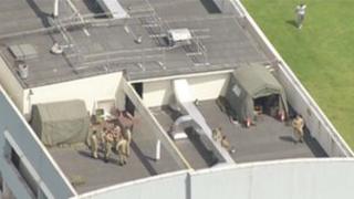 Army installing missiles on top of Fred Wigg Tower