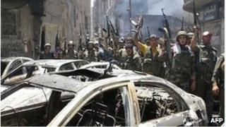 Syrian soldiers celebrate in the Midan area in Damascus on July 20