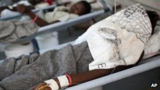 In this picture taken June 22, 2012, a woman suffering from cholera symptoms receives serum at a hospital run by the relief organization Doctors Without Borders in Port-au-Prince, Haiti.