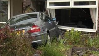 Car embedded in house