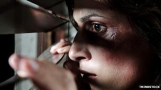 A generic picture of a domestic violence victim looking out of the window