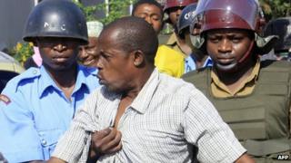 A sympathiser of the Mombasa Republican Council is arrested by riot-police on 24 April 2012 following violent confrontations in Kenya's coastal town of Mombasa