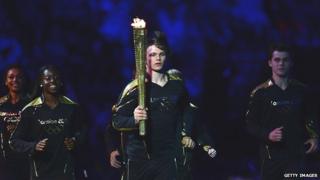 Aidan Reynolds carrying flame.