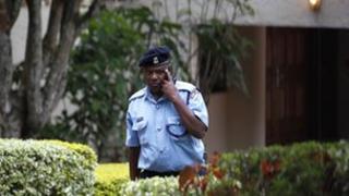 A police officer leaves the residence of the acting Ambassador, Olga Fonseca