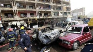 Emergency services personnel at the scene of one of the bombings in Baghdad (31 July 2012)