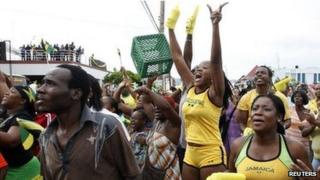 Jamaicans celebrate after Usain Bolt's success in men's 100m