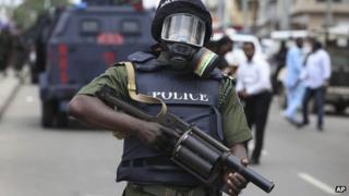 A Nigerian policeman holds a teargas launcher in Lagos on 1 June 2012