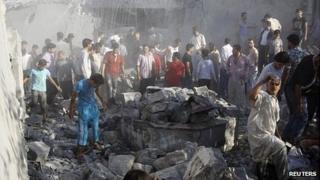 Men search rubble in Tal Rifaat, near Aleppo
