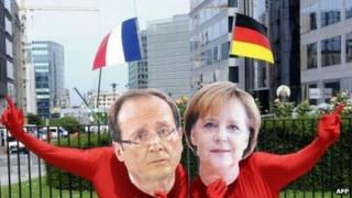 Activists disguised in European leaders French president Francois Hollande and German Chancellor Angela Merkel demonstrate
