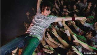 Person surfing the crowd in a mosh pit