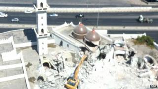 Shrine in Tripoli being attacked with a digger (photo supplied to the BBC by Tripoli resident)
