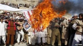 File picture of Afghans burning a US flag during riots over Koran burnings in Jalalabad, Afghanistan 24 February 2012