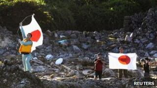 Члены японской националистической группы приземляются на острове Уотсури, который является частью спорных островов в Восточно-Китайском море, известных как острова Сенкаку в Японии и острова Дяоюй в Китае, на этой фотографии Киодо, 19 августа 2012 г.