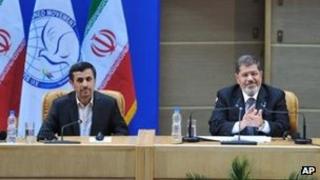 Iranian President Mahmoud Ahmadinejad, left, with Egyptian President Mohammed Morsi in Tehran 30 Aug
