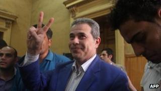 Tawfiq Ukasha gesturing as he arrives in court