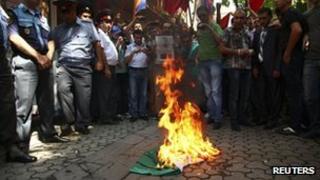 Armenian protesters burn a Hungarian national flag outside the Hungarian consulate in Yerevan. Photo: 1 September 2012