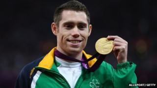 Jason Smyth on podium for Men's 100m - T13 final medal presentation