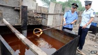 File photo: Police inspecting illegal cooking oil seized in 2010