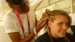 Amanda Fowler having her hair braided during the 2012 London Paralympic Games