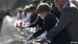 Andrew Timson, 7, etches the name of his late uncle Andrew Fisher during ceremonies marking the 11th anniversary of the 9/11 attacks on the World Trade Center in New York, September 11, 2012.
