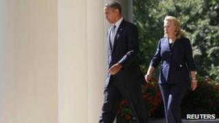 US President Barack Obama walks with Secretary of State Hillary Clinton to deliver remarks following the death of the US Ambassador to Libya 12 September 2012