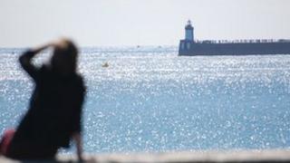 A woman watching the Guernsey Air Display from St Sampson