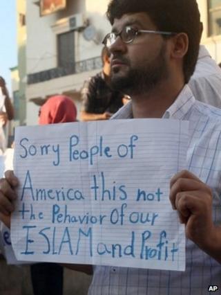 Libyan man holds a placard