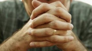 Man clasping hands