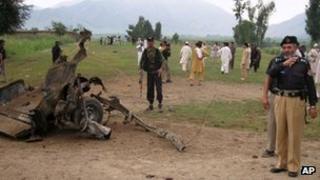 Police near the wreckage of the vehicle